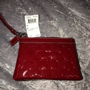 Red patent leather coach wristlet.